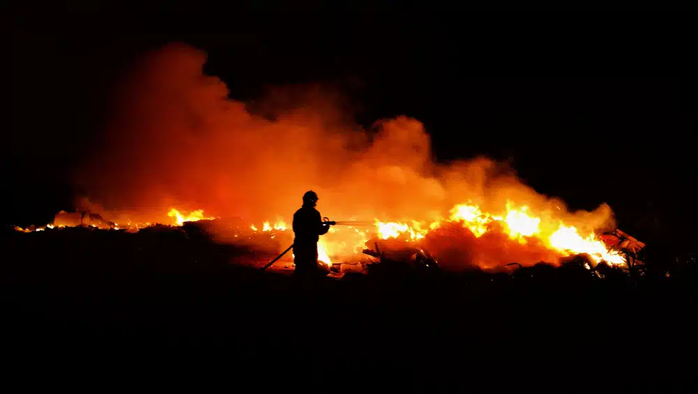 A Man In Front Of A Roaring Fire